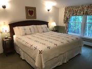 A king Select Comfort bed and two comfortable chairs. This room also offers a very large bathroom with an extra large sink, heated tile bathroom floor, and a combination Roman whirlpool tub and shower with tile surround.